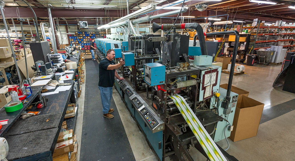 Man working on label printing machine